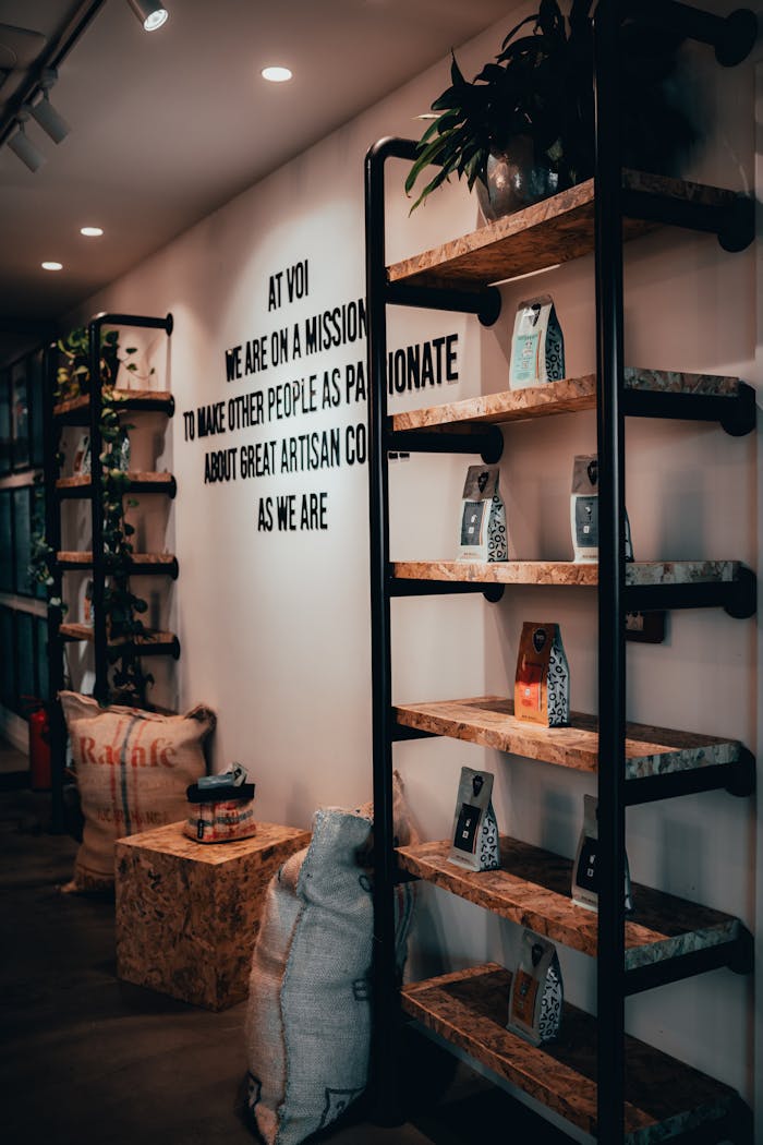 Stylish interior of a modern café with coffee bean bags and display shelves.